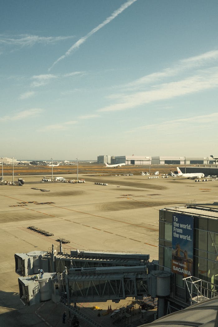 A bustling airport tarmac view with planes ready for departure under a clear sky.